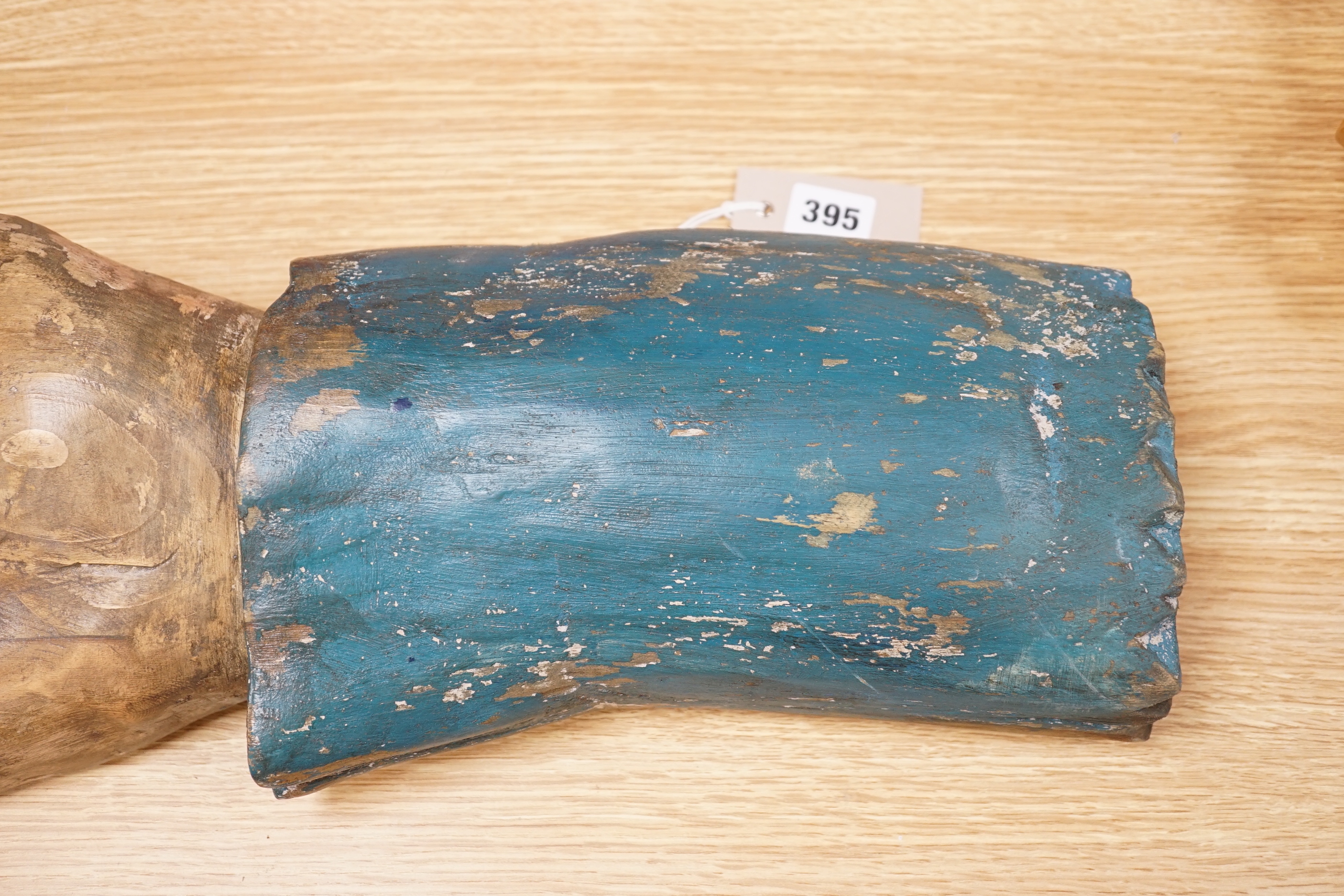 A carved wood and painted pointing forearm, 65cm wide
